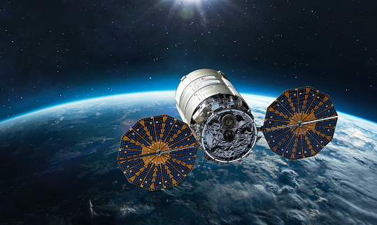 Cygnus spacecraft flight in space. Cygnus on orbit of Earth. Sci-fi wallpaper. Cargo expedition of Antares to ISS space station. Spaceship with astronauts. Elements of this image furnished by NASA (https://www.nasa.gov/sites/default/files/styles/full_width_feature/public/thumbnails/image/iss066e123388.jpg https://www.nasa.gov/sites/default/files/styles/full_width_feature/public/thumbnails/image/iss066e154853.jpg)