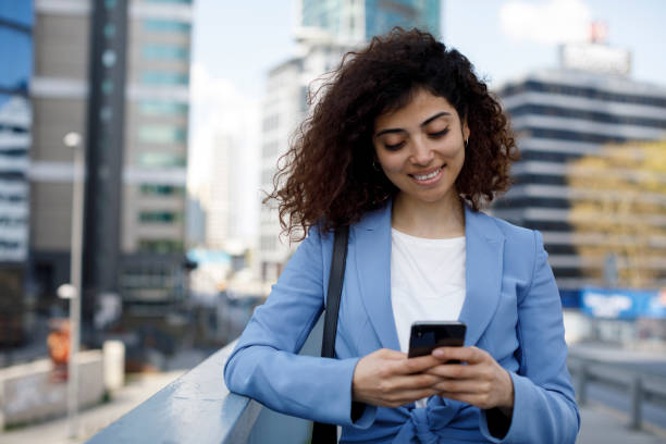 istock Young businesswoman using mobile phone outdoor 1394289070