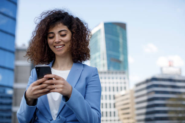 istock Young businesswoman using mobile phone outdoor 1394289072