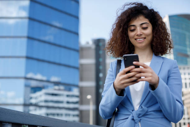 istock Young businesswoman using mobile phone outdoor 1394289089