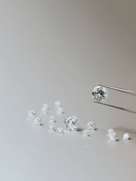 istock A round brilliant cut diamond held in tweezers 1394289140