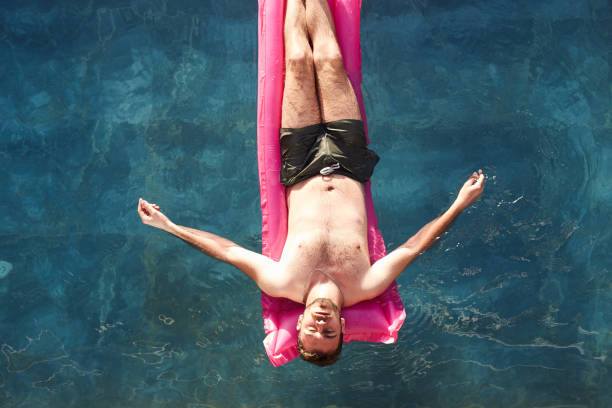 istock young couples enjoying the pool on weekend break 1394290011
