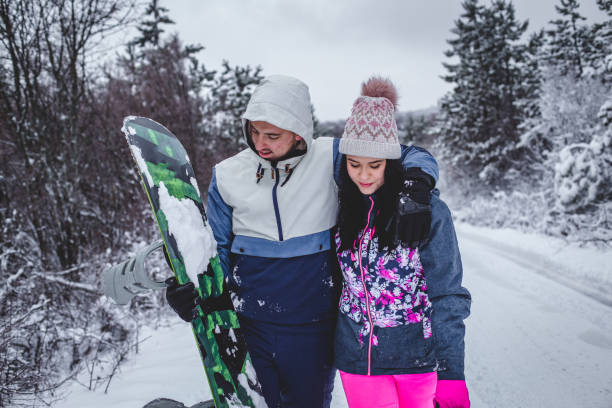 istock Couple walking hugged and enjoying the snow 1394290829
