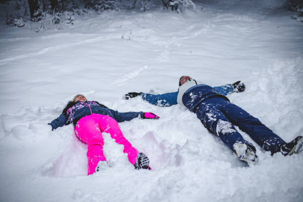 istock Couple  playing like a kids in the snow 1394290897