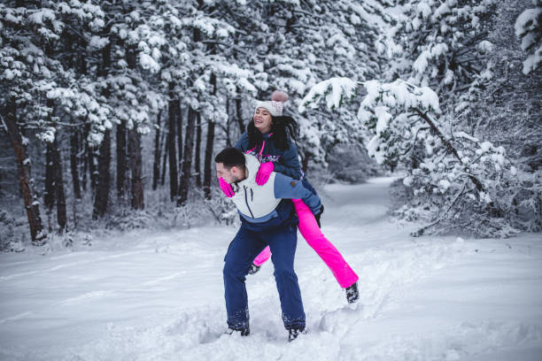 istock Couple  playing like a kids in the snow 1394290904