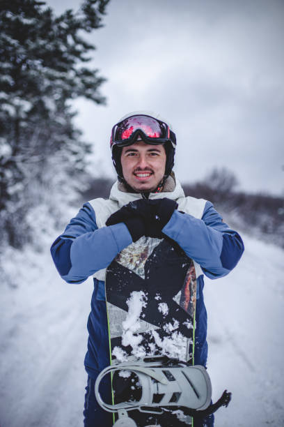 istock Couple  posing in a snowy forest with snowboard 1394290940