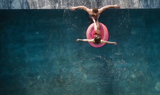 young couples enjoying the pool on weekend break
view from above