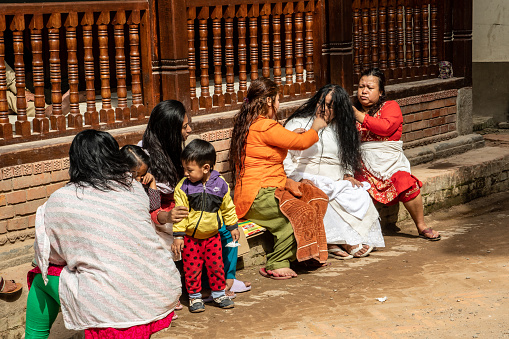 Madhyapur Thimi, Nepal - oct 28, 2019:  Nepalese women of the Newa ethnicity make their hair freshly washed in a street in the village of Thimi, Kathmandu Valley