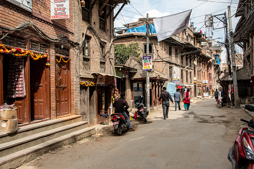 Madhyapur Thimi, Nepal - oct 28, 2019: the typical Nepalese red brick houses are almost suffocated by an intrigue of electric cables, Thimi, Kathmandu Valley, Nepal