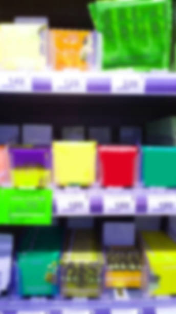 Abstract blur image of supermarket display background. Defocused shelves with products, chocolate. Grocery shopping. Store. Retail industry. Food. Rack. Discount. Inflation and crisis concept. Aisle Abstract blur image of supermarket display background. Defocused shelves with products, chocolate. Grocery shopping. Store. Retail industry. Food. Rack. Discount. Inflation and crisis concept. Aisle mark goodson screening room stock pictures, royalty-free photos & images