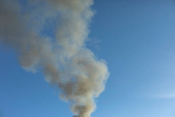 Smoke and sky. Black smoke billows in air. stock photo