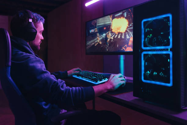 istock Pro gamer splaying multiplayer computer video game in dark neon room 1394295011