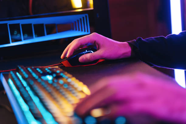 istock Close up of man gamer's hands using professional computer mouse and keyboard for playing video game 1394301271