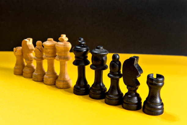 istock chess pieces on yellow and black background, chess game. 1394302820