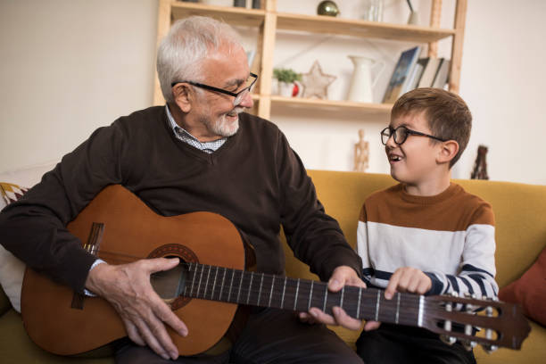 istock Grandpa playing a guitar for his grandson 1394307710