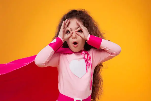 Photo of Astonished superhero girl with glasses gesture