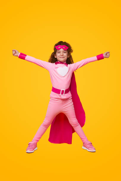 istock Excited superhero girl with arms raised 1394308055