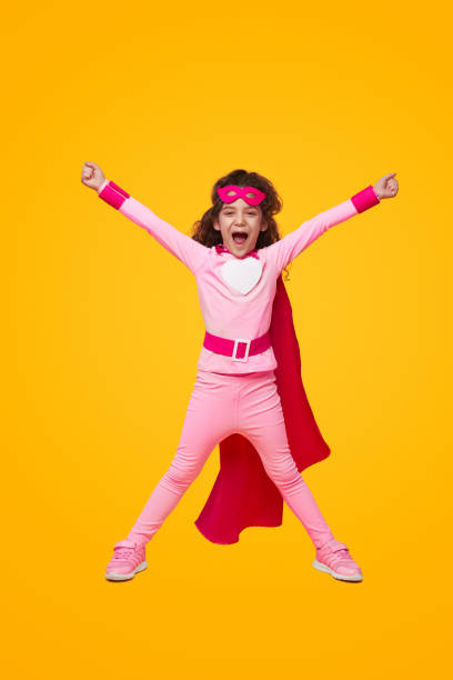 istock Excited superhero kid celebrating victory with raised arms 1394308058
