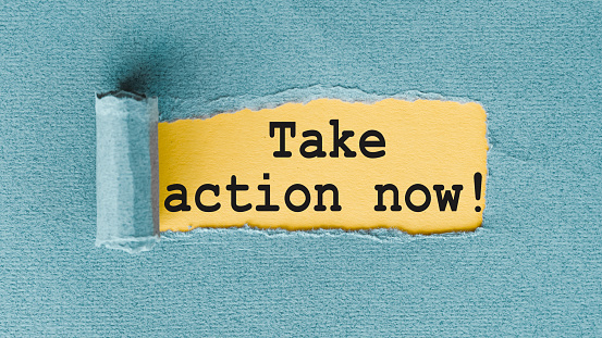 Take Action Now - words written under ripped and torn paper.