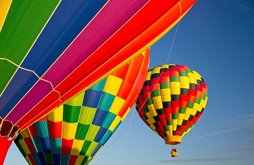 three multicolored hot air balloons in the blue sky, canada