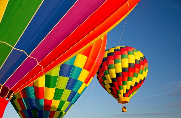 Hot balloons in the sky, canada three multicolored hot air balloons in the blue sky, canada hot air balloon stock pictures, royalty-free photos & images