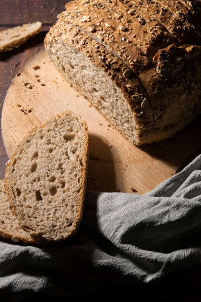istock Sliced wholemeal bread with seeds on rustic wooden table 1394316617