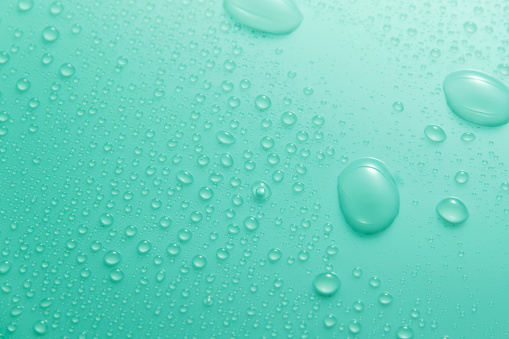 close up of water droplet on blue background