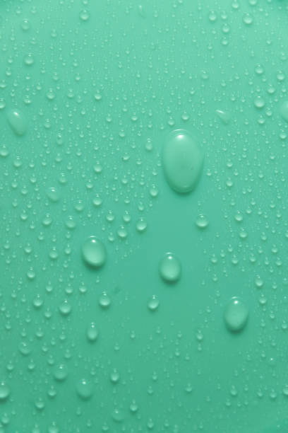 istock Blue pastel water drops on light shiny surface 1394316686