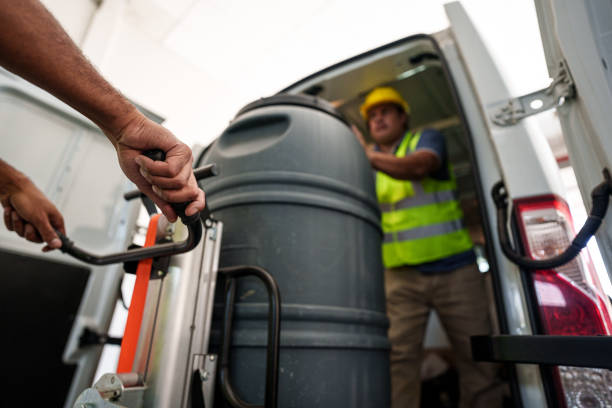 istock Workers carrying a barrel inside a van for delivery 1394317125