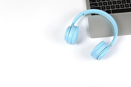 light bule headphones with laptop on white surface. Ideas for music festivals, radio stations, music lovers, live with music, minimalist style and modernity.