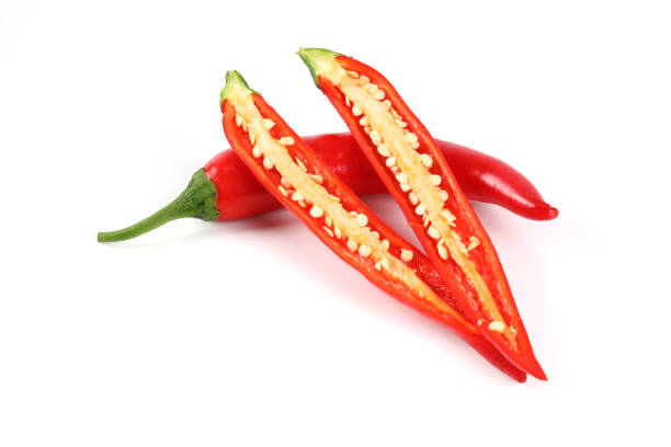 istock Fresh red chilli, halved on a white background close-up view on white 1394328250