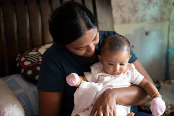 istock Young mother carries infant daughter 1394330127