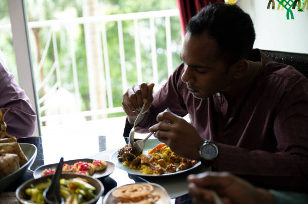 istock Man digs into meal 1394330203