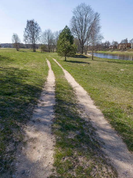 istock Rarely used country road in sunny spring day. 1394330817