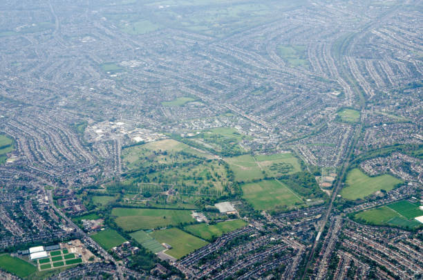 View looking south across New Malden, Morden and Motspur Park, London Aerial view looking south from New Malden towards Motspur Park, Tolworth, Morden and Cheam in the London Boroughs of Kingston-Upon-Thames and Sutton on a sunny Spring morning. The grounds of the North East Surrey Crematorium are towards the bottom of the image. sutton park stock pictures, royalty-free photos & images
