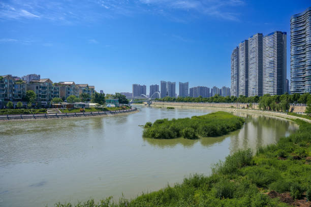 istock A modern park with bridges, grass and modern buildings on a sunny day 1394332728