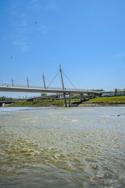 istock A modern park with bridges, grass and modern buildings on a sunny day 1394332737