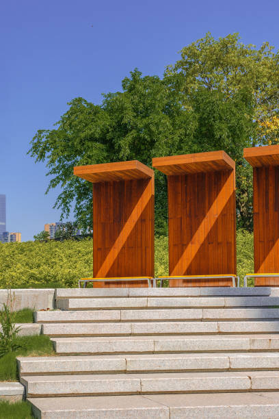 istock A modern park with bridges, grass and modern buildings on a sunny day 1394332740