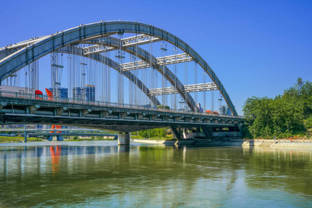 istock A modern park with bridges, grass and modern buildings on a sunny day 1394332747