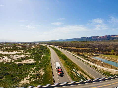 Alongside Colorado River Basin Aerial Drone View of Vehicles and Semi Trucks Driving on Interstate 70 in Western USA Fruita Colorado Photo Series Matching 4K video Available