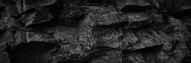 istock Black white rock texture. Rough mountain surface. Close-up. Volumetric stone background with space for design. Dark gray grunge backdrop. 1394333850