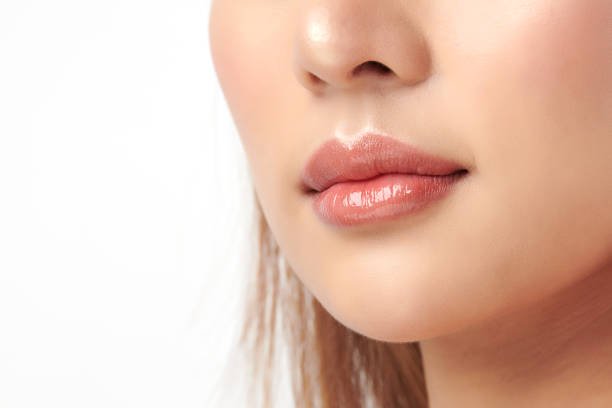 Close up photo with beautiful female face, Sexy plump full lips. Close-up face detail. Perfect natural lip makeup. Close up photo with beautiful female face, Sexy plump full lips. Close-up face detail. Perfect natural lip makeup. human lips stock pictures, royalty-free photos & images