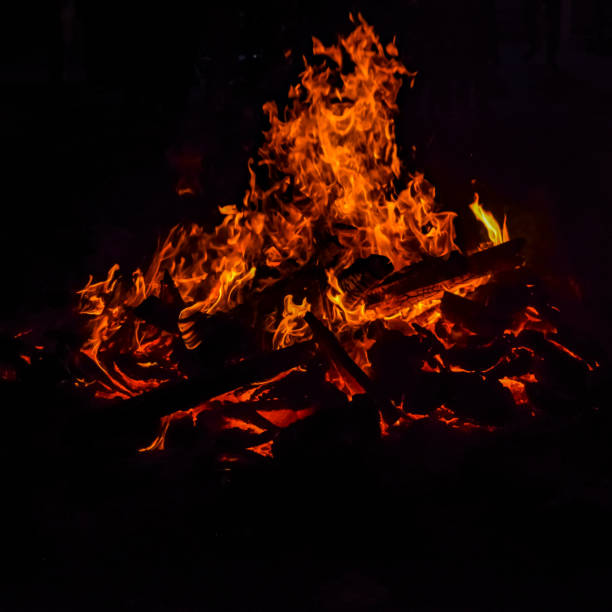 istock Fire flames on black background, Blaze fire flame texture background, Beautifully, the fire is burning, Fire flames with wood and cow dung bonfire 1394337603