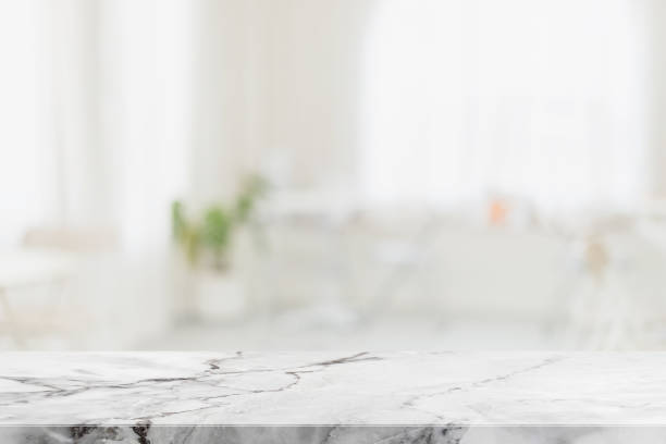 istock Empty white marble stone table top and blur glass window interior restaurant banner mock up abstract background - can used for display or montage your products. 1394339229