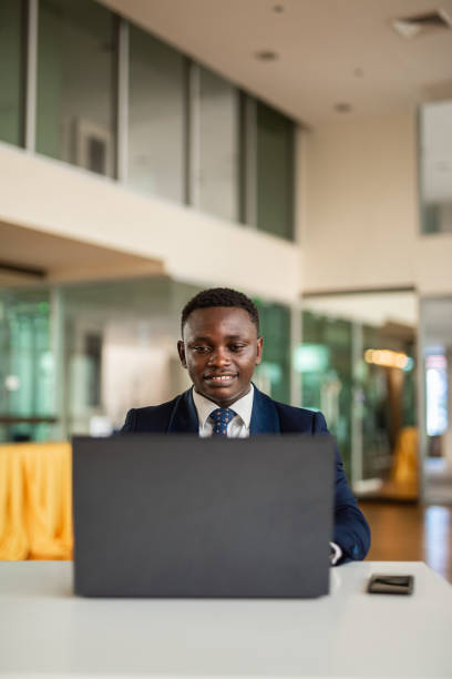 istock Portrait of handsome African businessman using laptop computer 1394340468