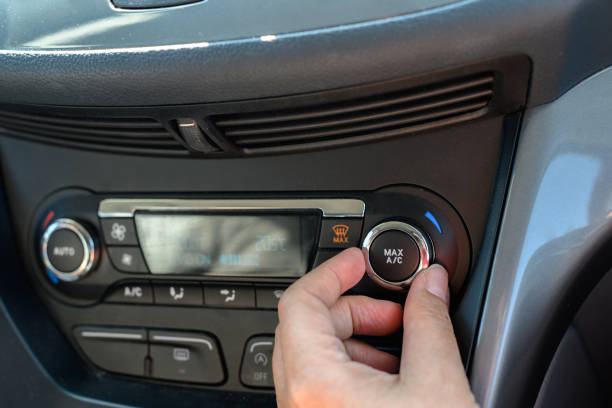 istock Hand turning on a car air conditioner 1394343010