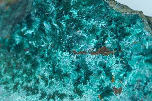 Macro shooting of natural gemstone. Raw mineral amazonite. Isolated object on a white background