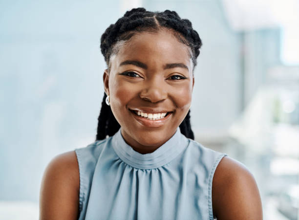 Confident black businesswoman working in an office alone stock photo