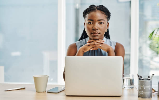 istock Young african businesswoman looking focused while working on a laptop in an office alone 1394347329