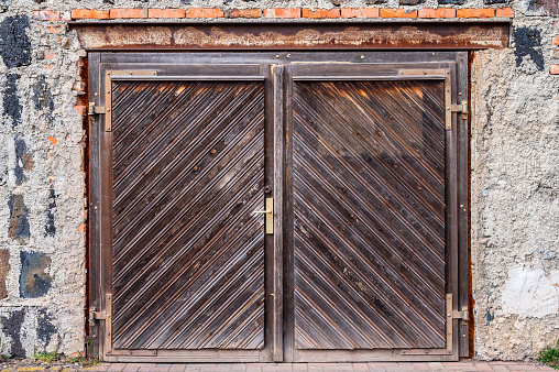 An old weathered wooden gate or door in a historic building
